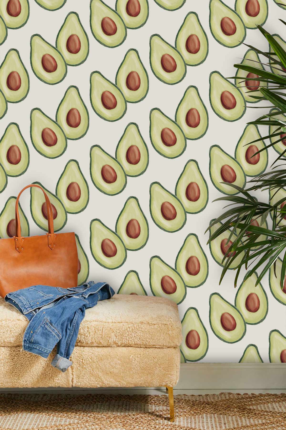 Trendy avocado wallpaper, cream style, tan ottoman, brown leather bag, casual denim, green plant accents.