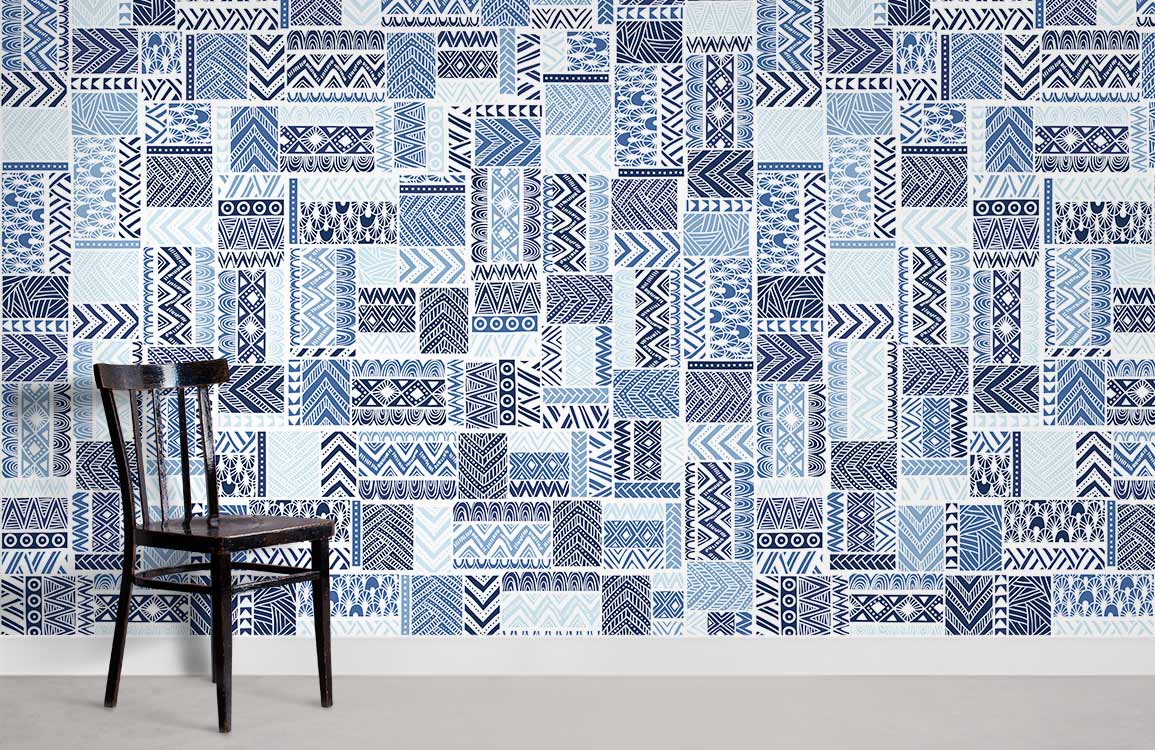Contemporary blue geometric tribal pattern wallpaper in modern room with wooden chair and grey flooring.
