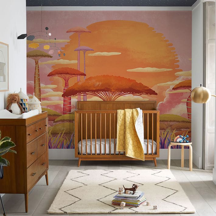 Vibrant Sunset Fantasy Wallpaper, pink and orange hues, nursery room, wooden crib, modern dresser, rug.