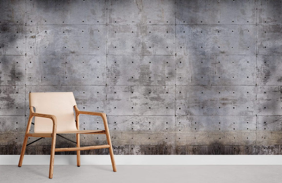 Industrial grey concrete-effect wallpaper in modern living room with beige wooden chair and grey floor.