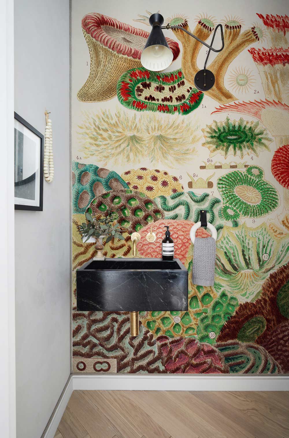 Vintage Coral Reef Botanical Mural Wallpaper in earthy tones; bathroom with black sink, wooden flooring.