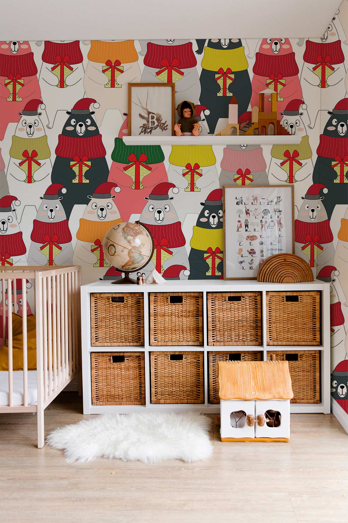 Cosy nursery featuring Festive Bears wallpaper with colourful jumpers; wicker storage and light wooden floor.