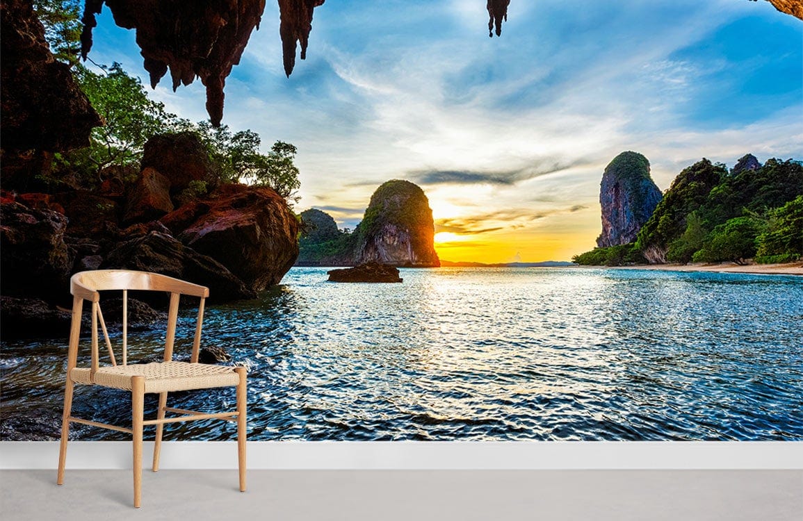Sunset beach cave wall mural, wooden chair, serene nature Décor, living room, tranquil ambience enhancement.