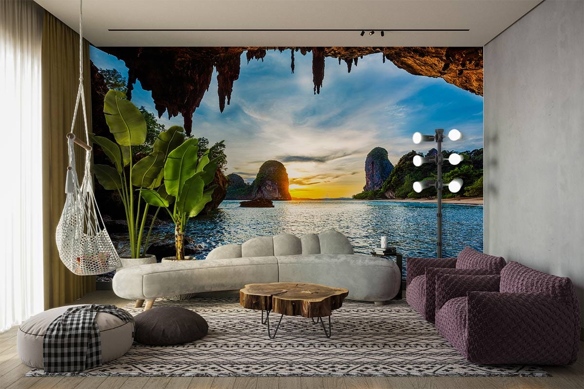 Serene Sunset Beach Cave Wall Mural in modern living room with grey sofa, rustic table, and floor lamp.