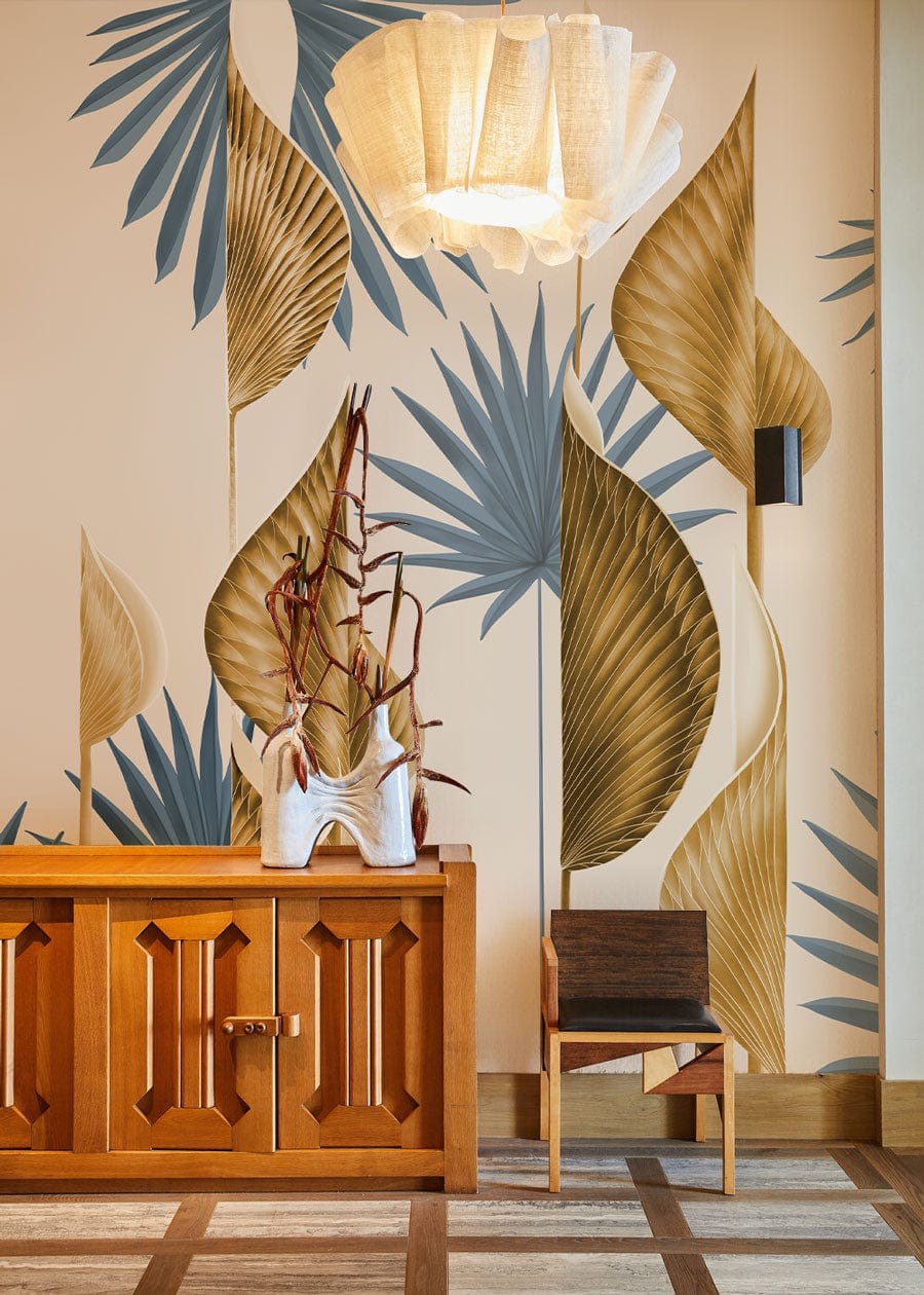 Elegant wall with leaf pattern wallpaper, wooden cabinet, modern chair, pendant light, parquet flooring.