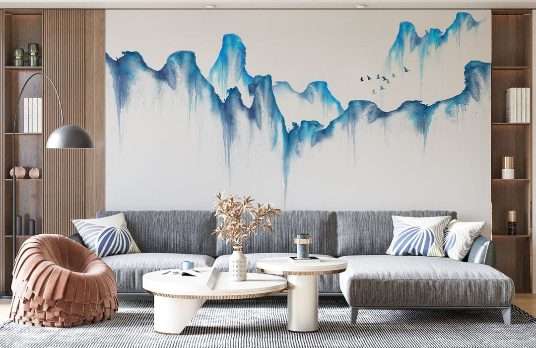 Tranquil Blue Watercolour Mountain Mural Wallpaper, grey sofa, modern living room, brown armchair, shelving.