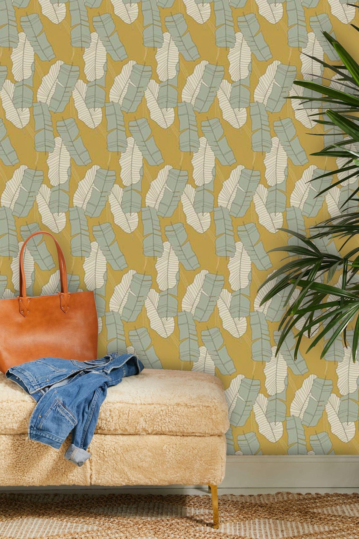 Vintage mustard and aqua geometric wallpaper, retro interiors, beige rug, plush beige bench, green plant.