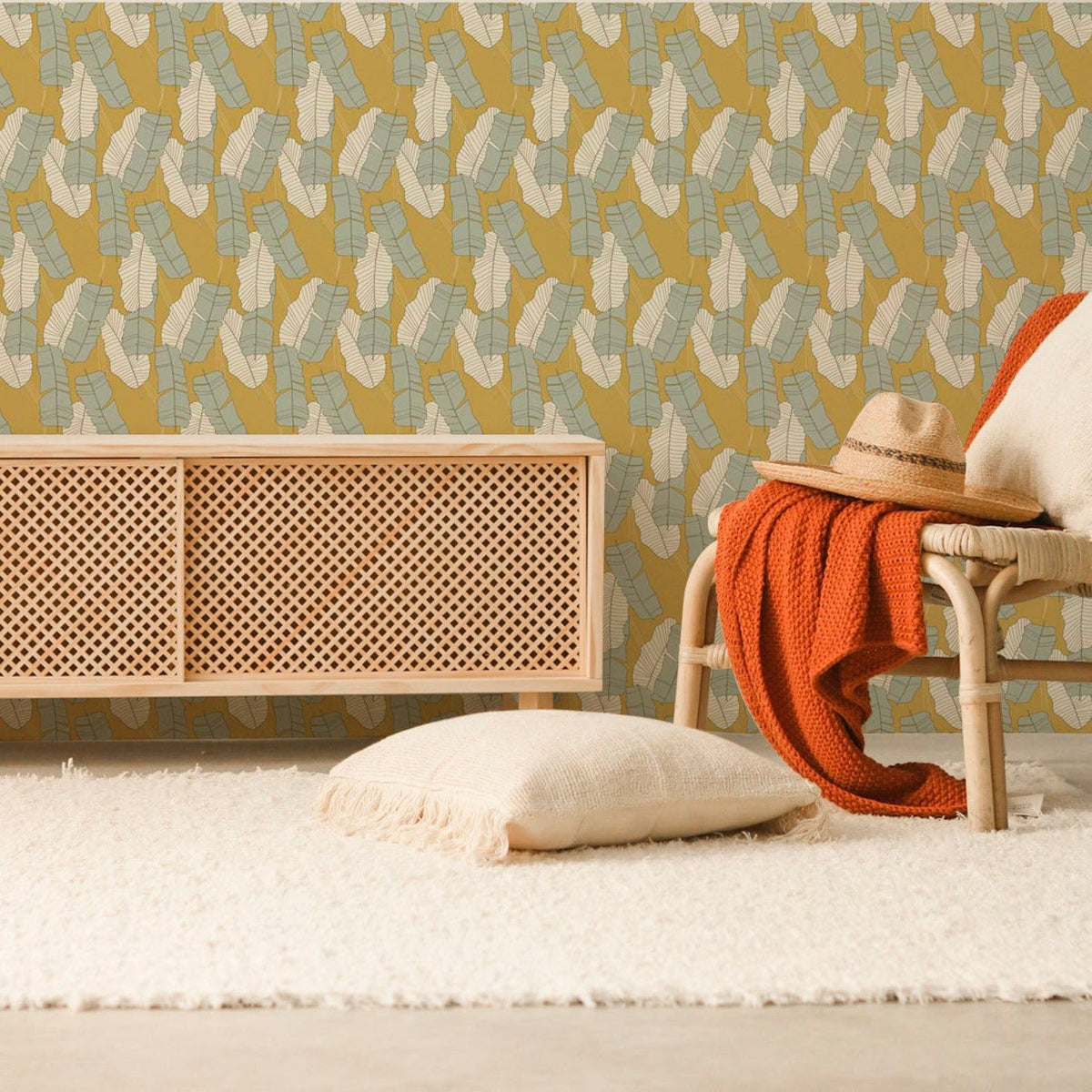 Vintage Mustard and Aqua Geometric Pattern Wallpaper in retro living room with cane furniture.
