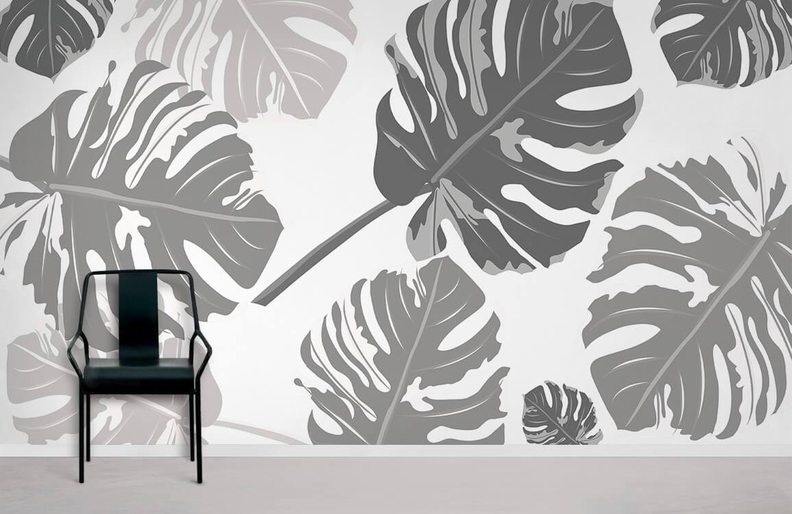 Elegant grey botanical wallpaper with monochrome Monstera leaf pattern, black chair, modern room setting.