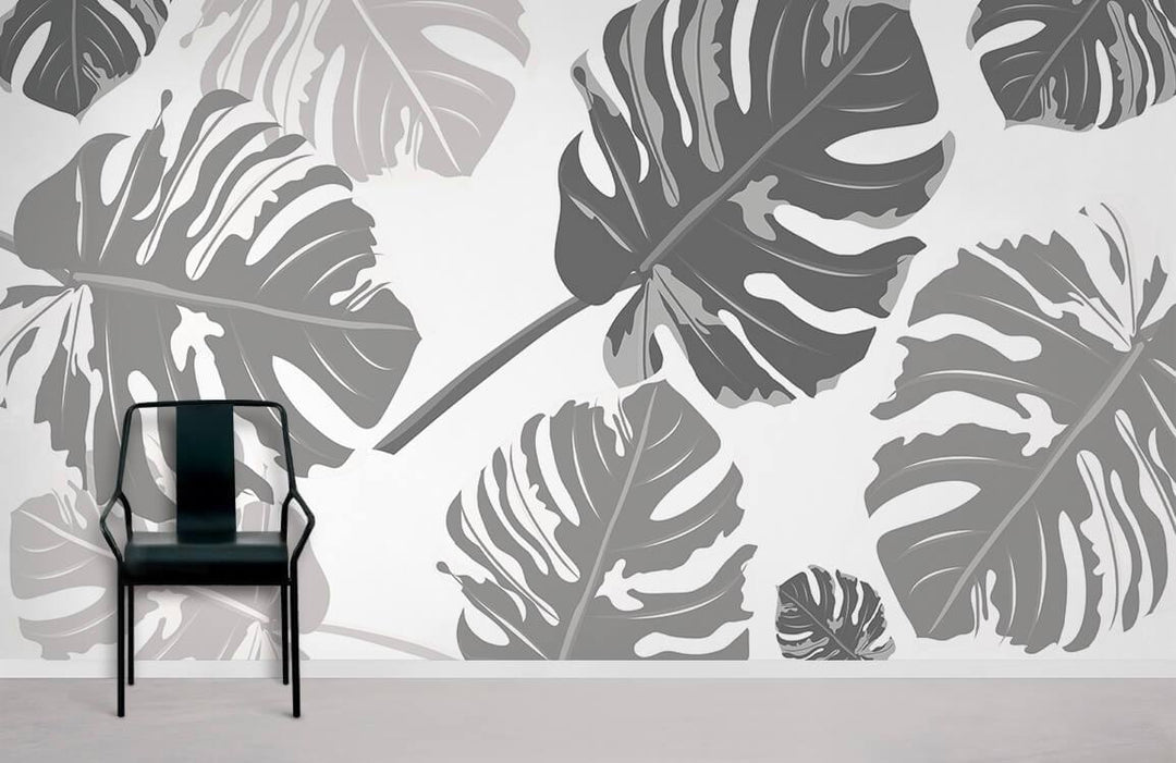 Elegant grey botanical wallpaper with monochrome Monstera leaf pattern, black chair, modern room setting.