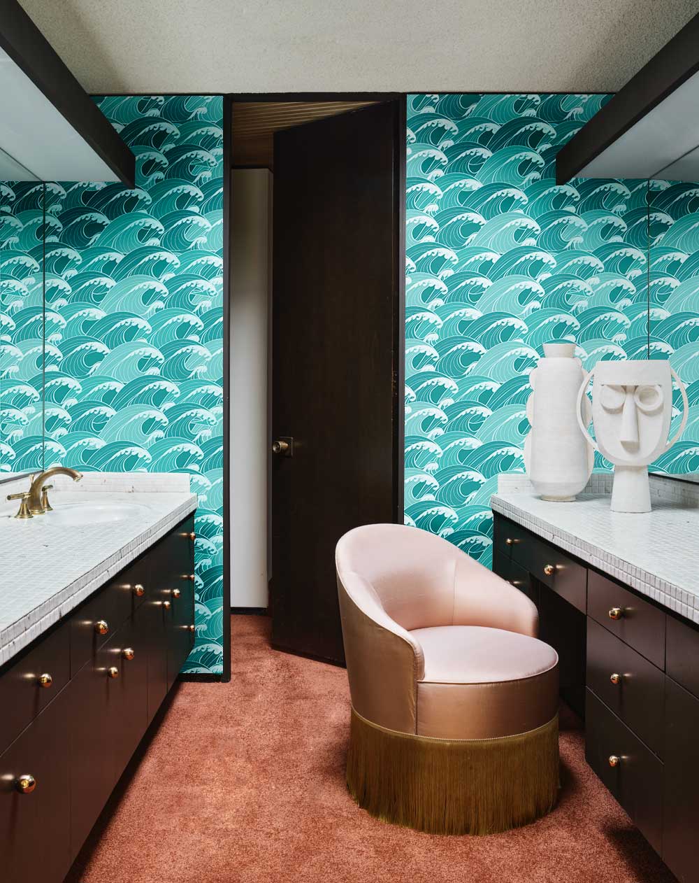 Aqua Marine vintage wave wallpaper in coastal-themed bathroom with pink chair and plush brown carpet.