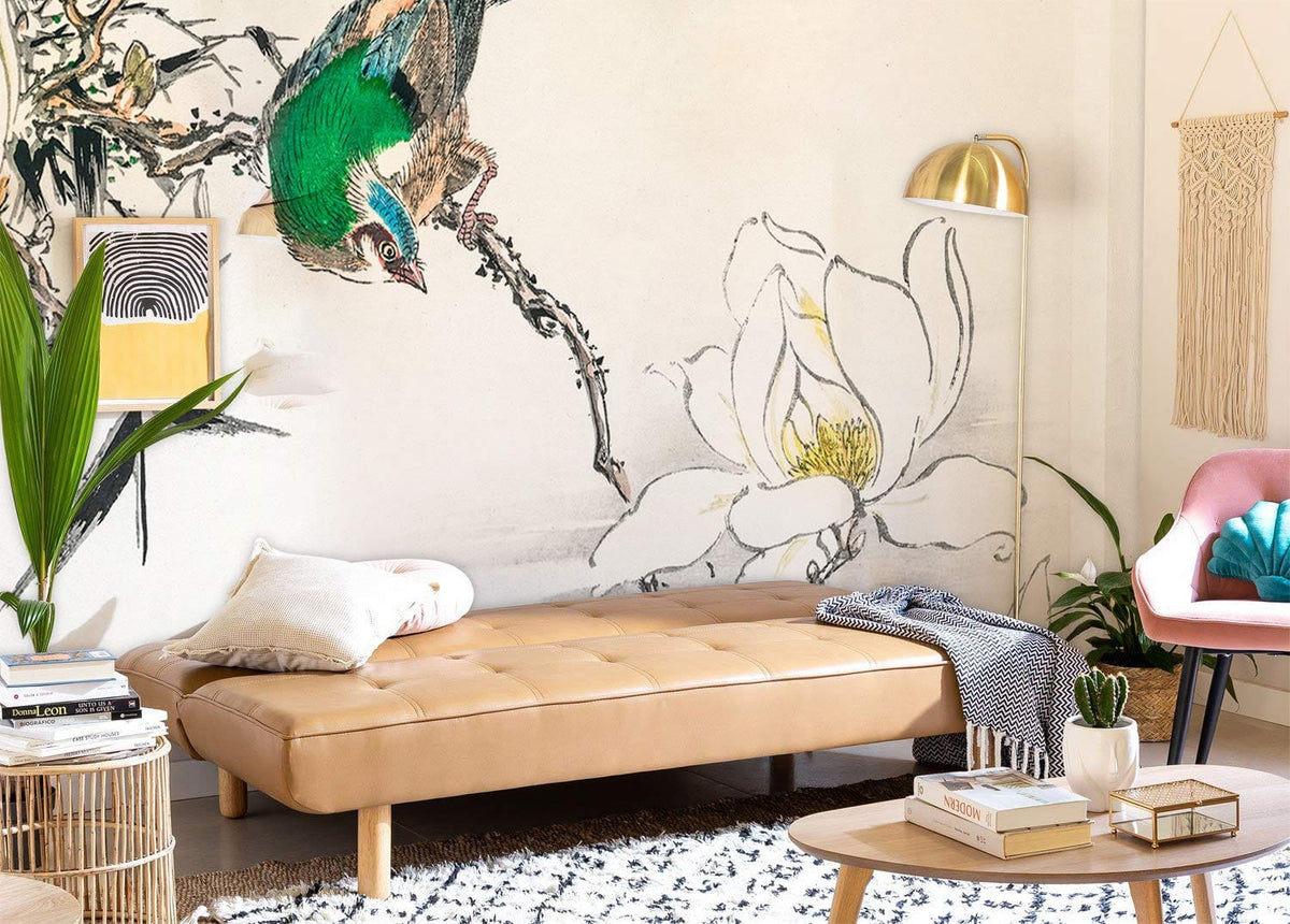 Elegant mural wallpaper with green bird, white magnolia, and tan sofa in cosy living room setting.