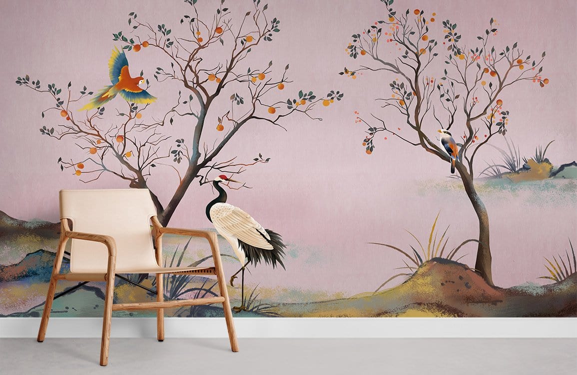Vintage Oriental Crane Mural Wallpaper with birds, beige armchair, concrete flooring, and pink backdrop.