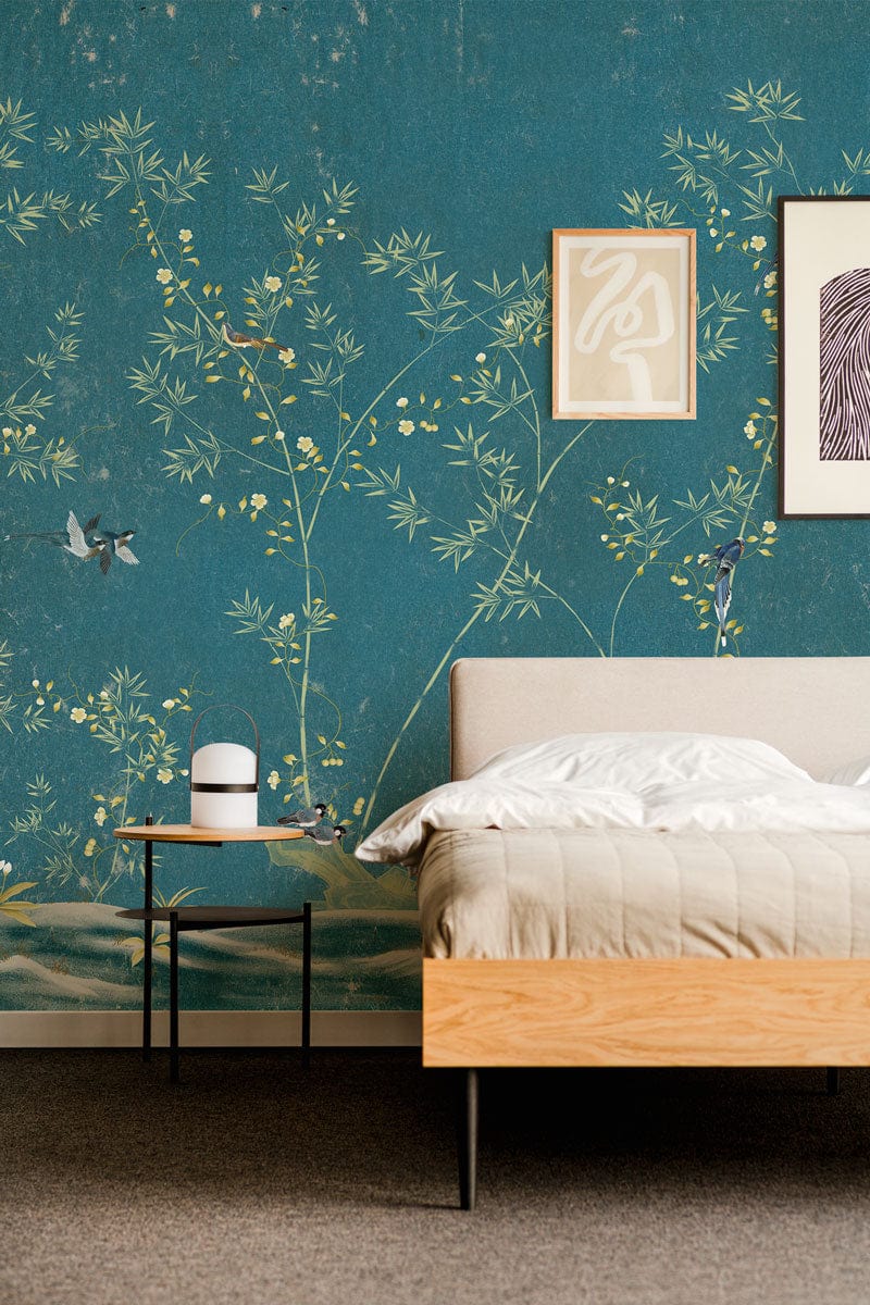 Elegant teal Chinoiserie wallpaper with floral pattern, beige bed, light wood, bedroom decor, grey carpet.