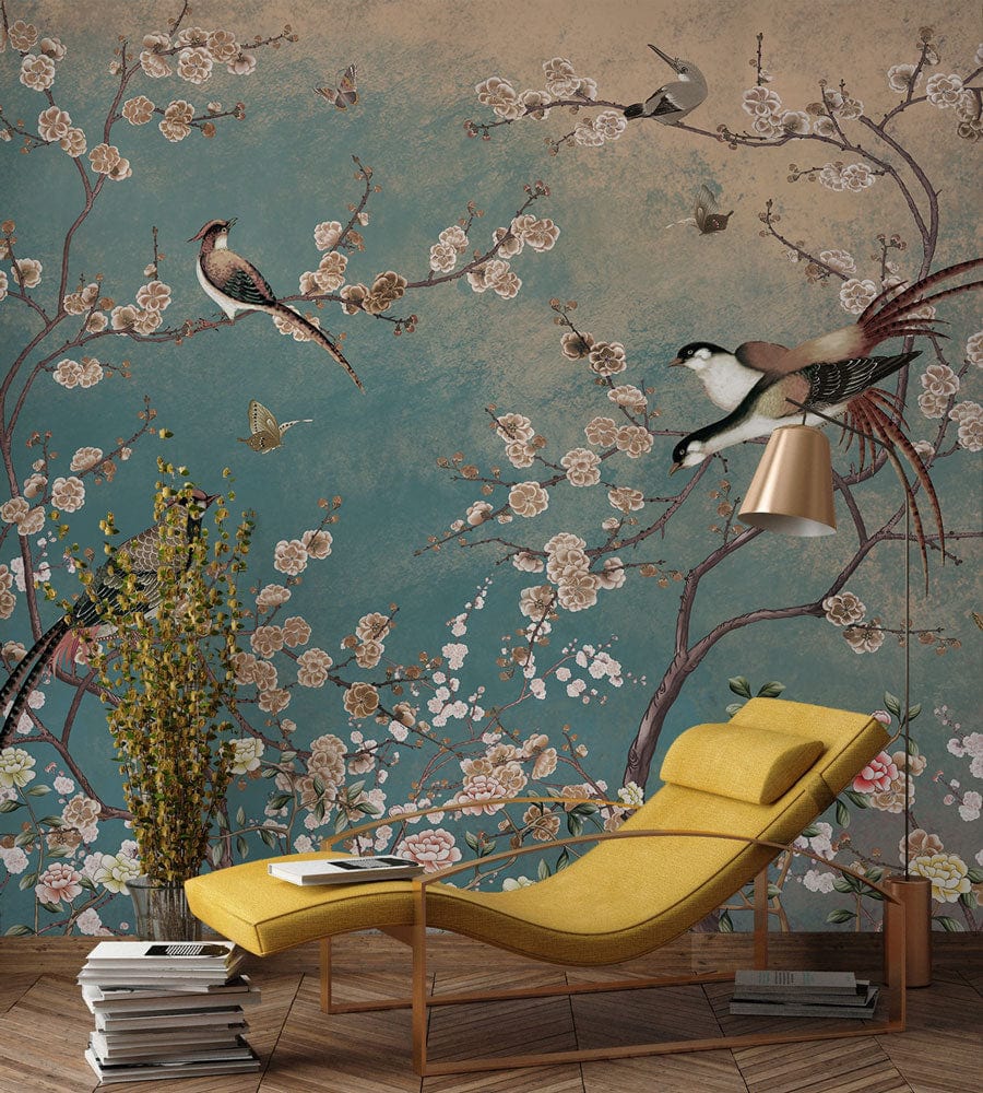 Elegant vintage chinoiserie mural wallpaper in teal and gold with yellow chaise longue, wooden flooring.