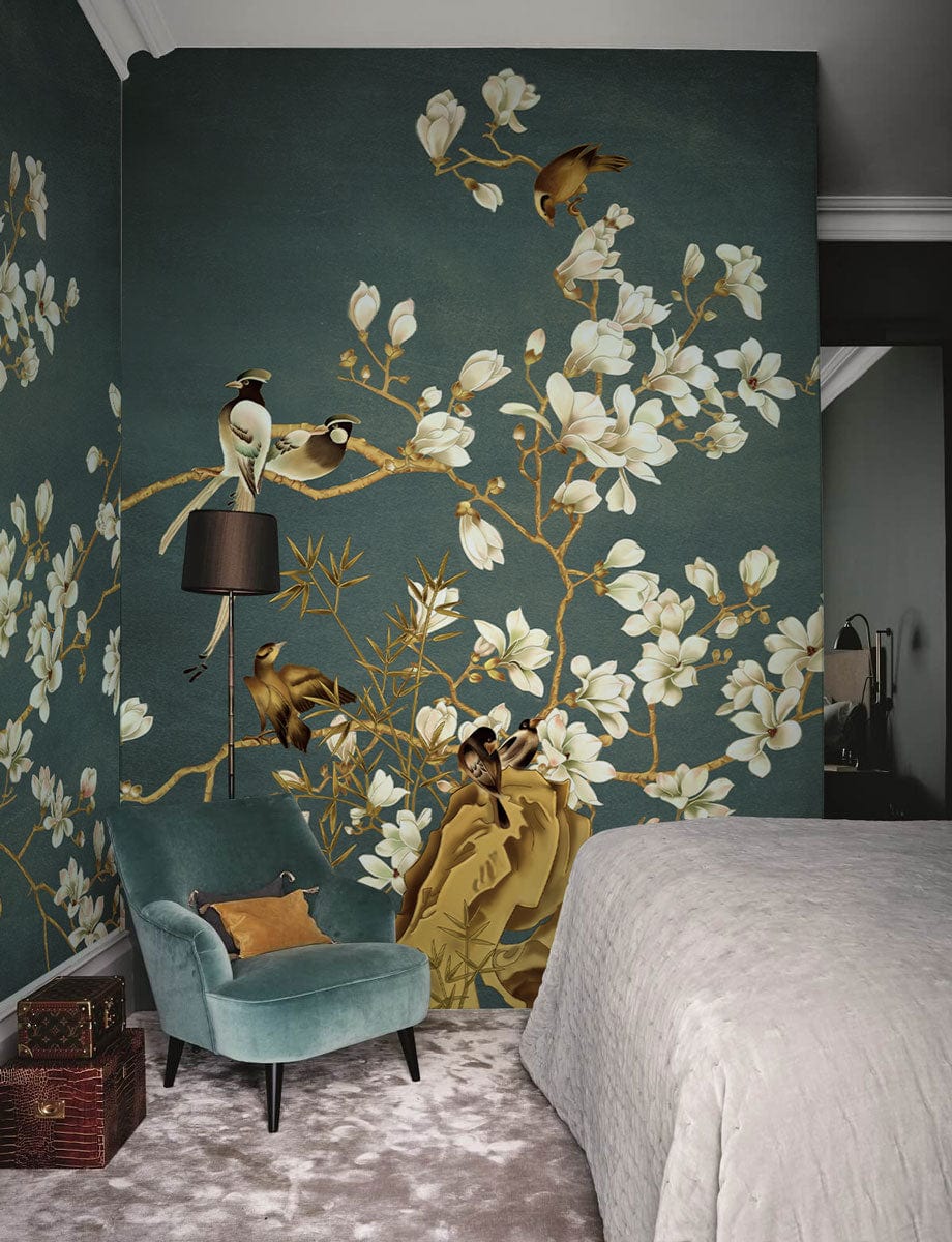 Elegant botanical bird mural wallpaper in bedroom, blue walls, white blossoms, velvet armchair, carpet flooring.