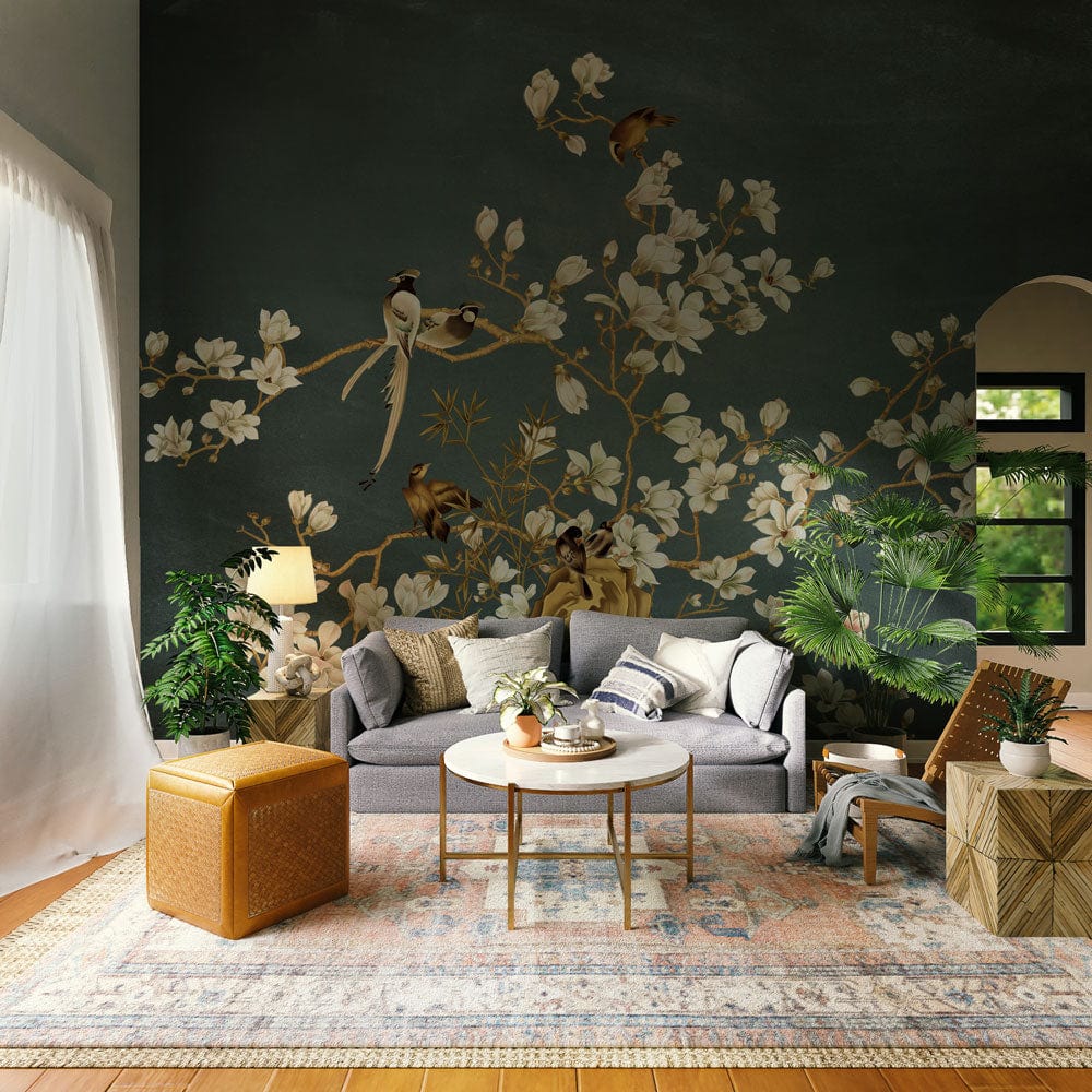 Elegant blue bird and blossom mural wallpaper in living room with grey sofa, wooden flooring, plants.