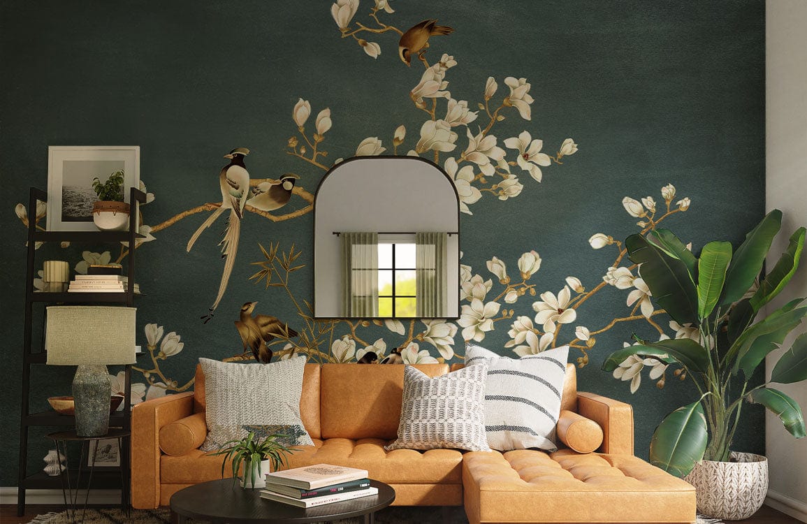Elegant wallpaper with birds and blooms, orange sofa, green wall, arched mirror, large plant, cosy lounge.