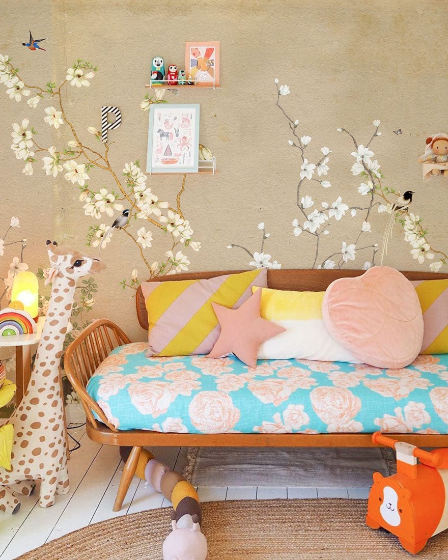 Beige floral bird mural wallpaper, child's room with colourful sofa and playful decor, white flooring.