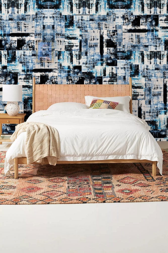 Abstract Urban Blue Geometric Pattern Wallpaper, modern bedroom decor, beige bed, colourful rug, white bedding.