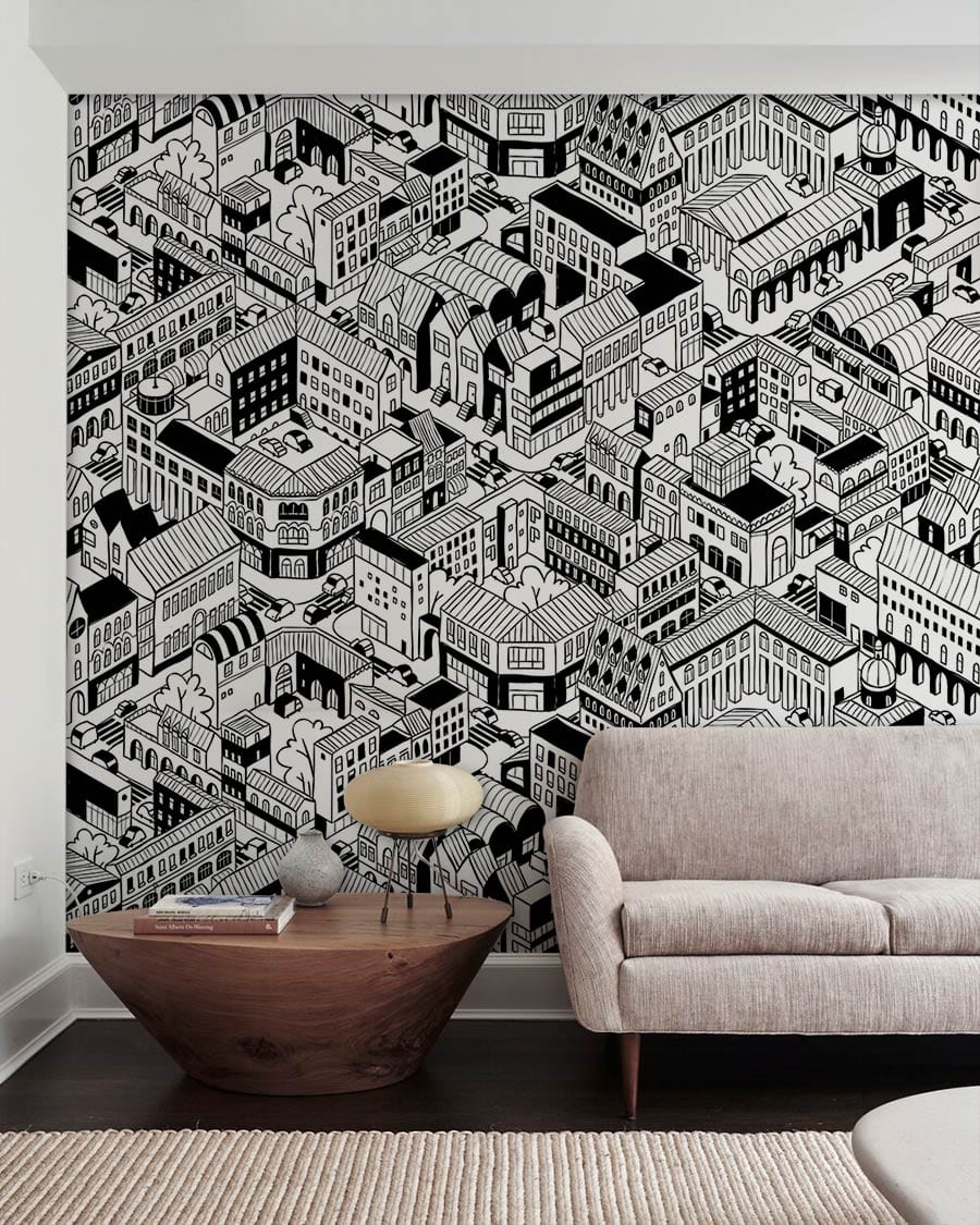 Contemporary wallpaper with monochrome urban cityscape design, featuring beige sofa, wooden table, and rug.
