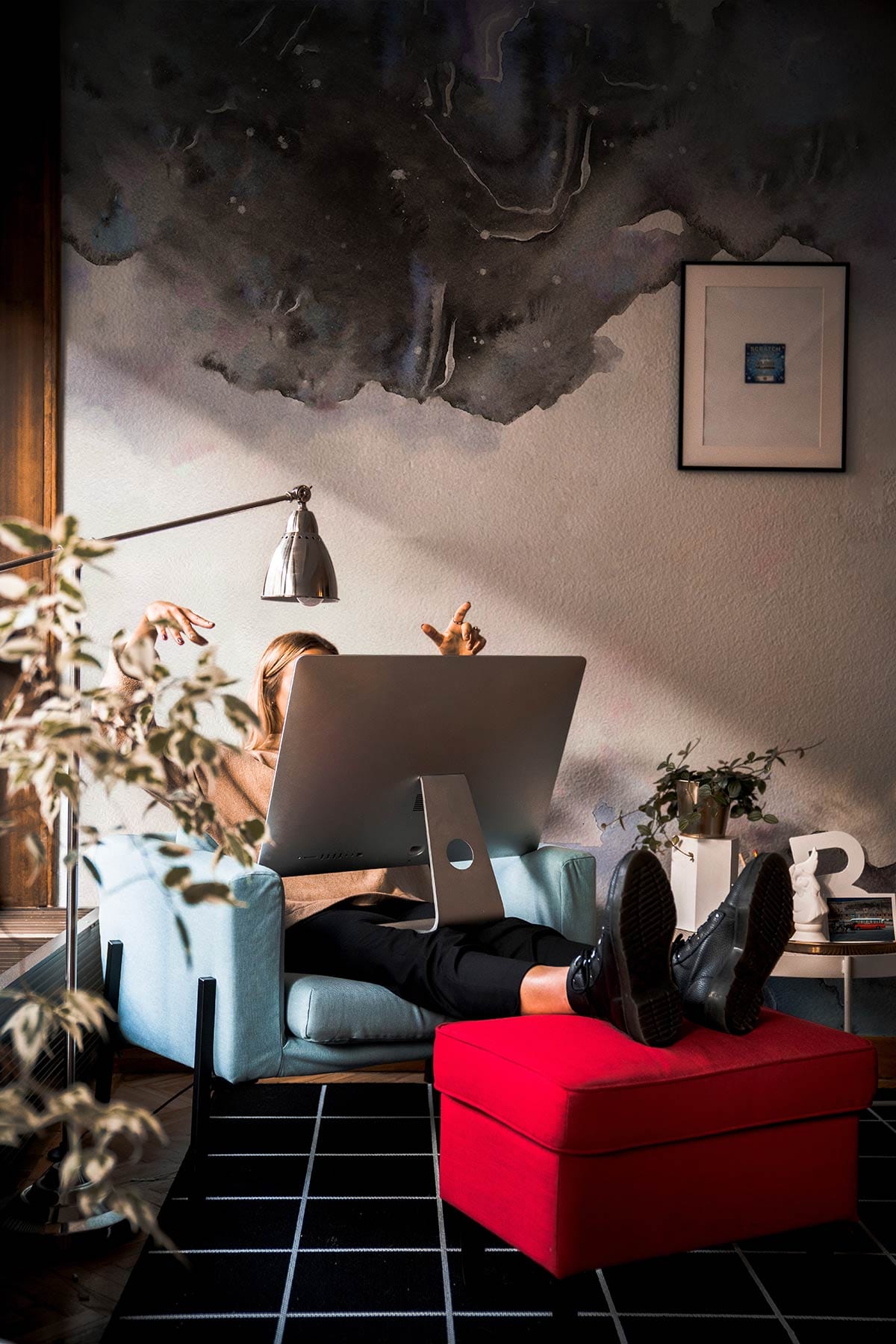 Abstract Watercolour Mountain Mural Wallpaper; grey-blue tones, cosy room, blue armchair, red footstool, framed art.