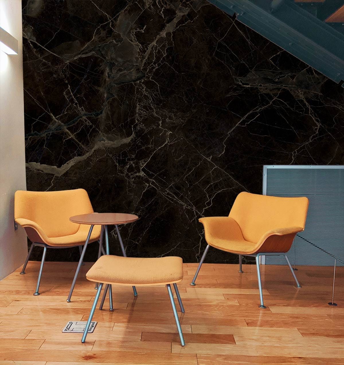 Luxury dark marble wallpaper in modern lounge with veined pattern, orange chairs, and wooden flooring.