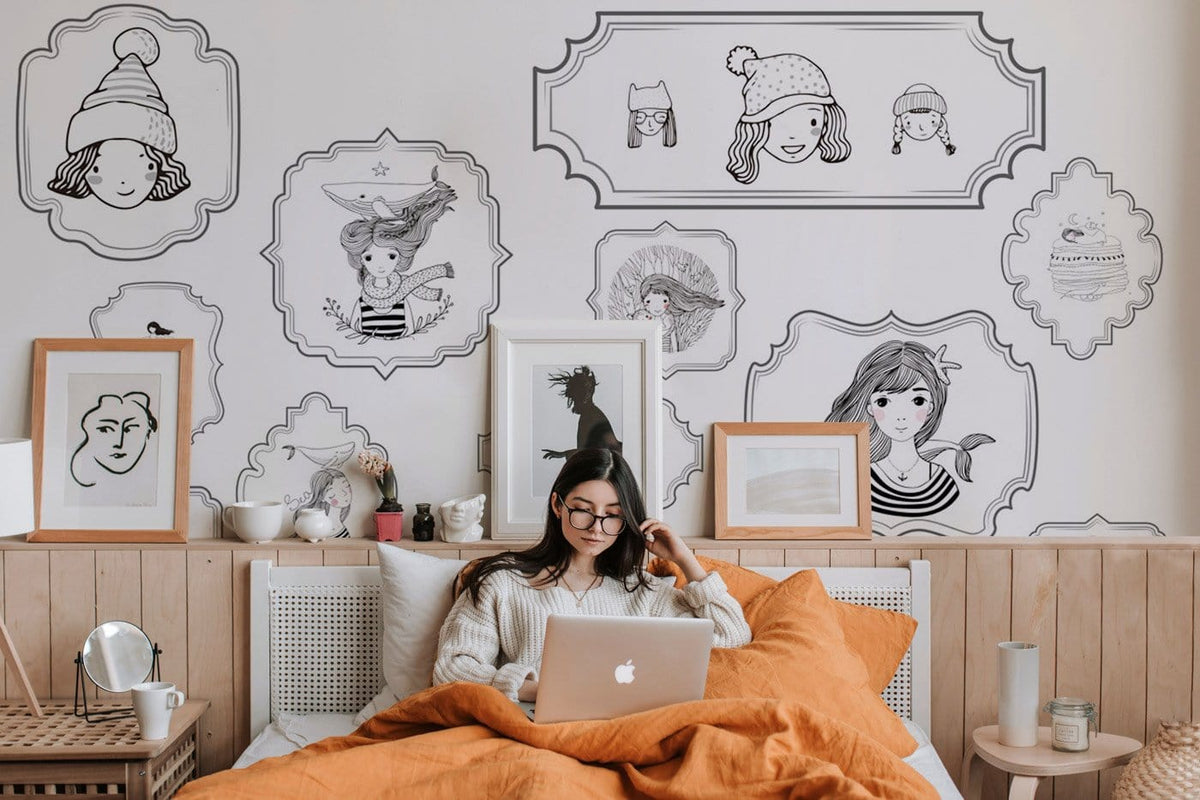 Black and white illustration mural wallpaper, bedroom setting with cosy bed, wooden panelling, framed art.