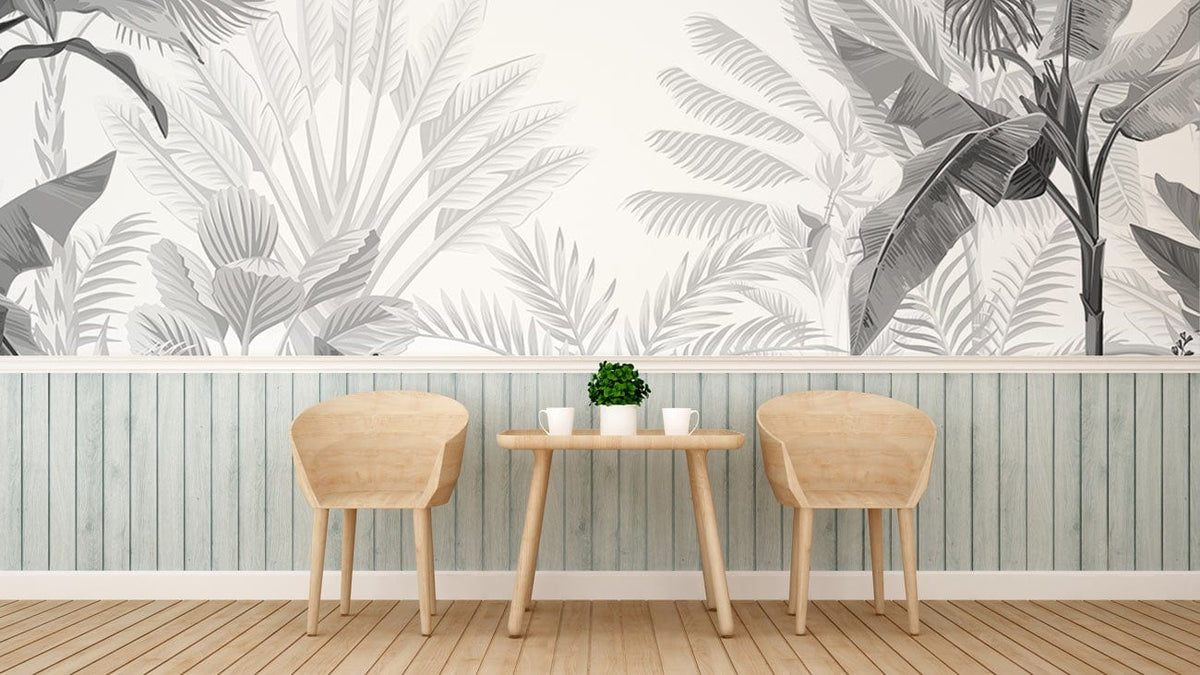 Monochrome tropical jungle mural wallpaper with wooden chairs, white coffee table, light wood flooring in interior.