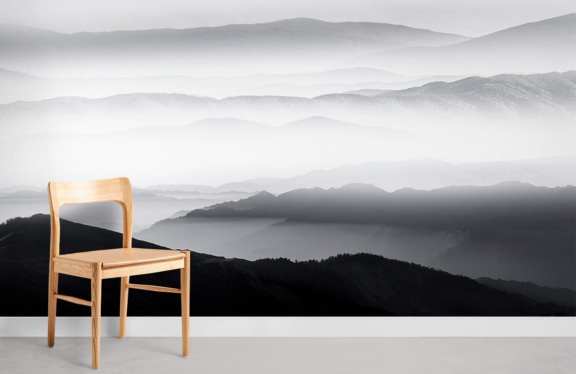 Misty Mountains Grey Scenic Mural Wallpaper in modern interior with wooden chair and minimalist design.