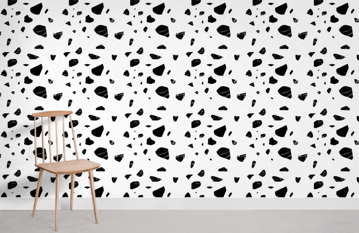 Monochrome geometric terrazzo pattern wallpaper with wooden chair, modern minimalist interior style.