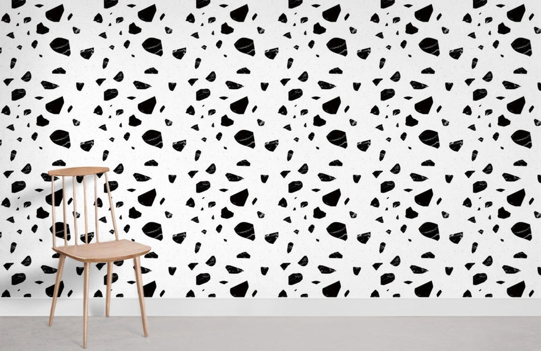 Monochrome geometric terrazzo pattern wallpaper with wooden chair, modern minimalist interior style.