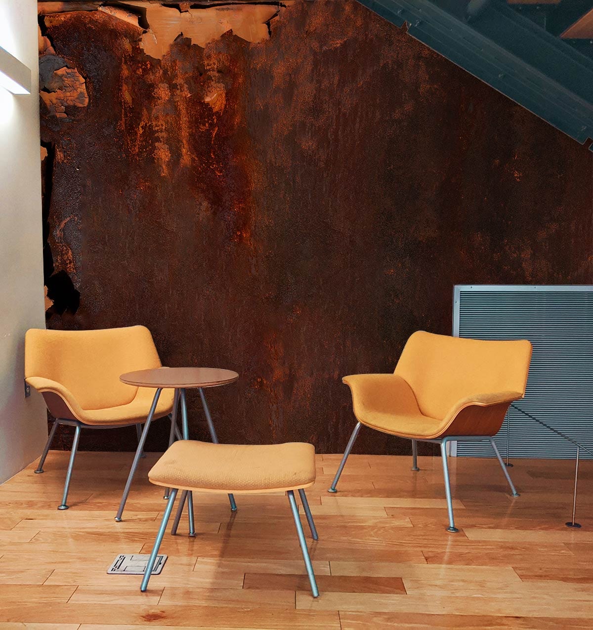 Rustic industrial mural behind mustard chairs on wooden flooring in stylish modern interior scene.