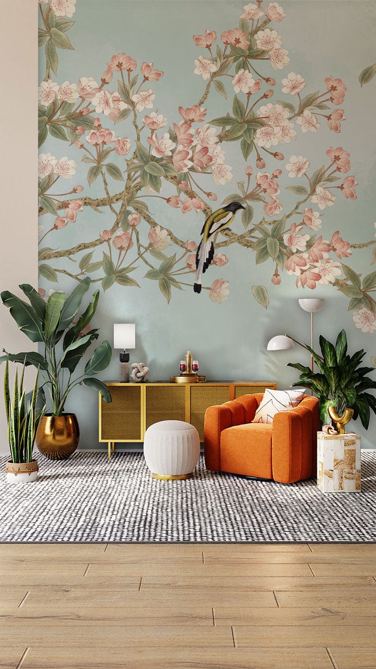 Tranquil Sky Blossom Mural Wallpaper, pastel tones, featuring bright orange sofa, wooden flooring, elegant decor.