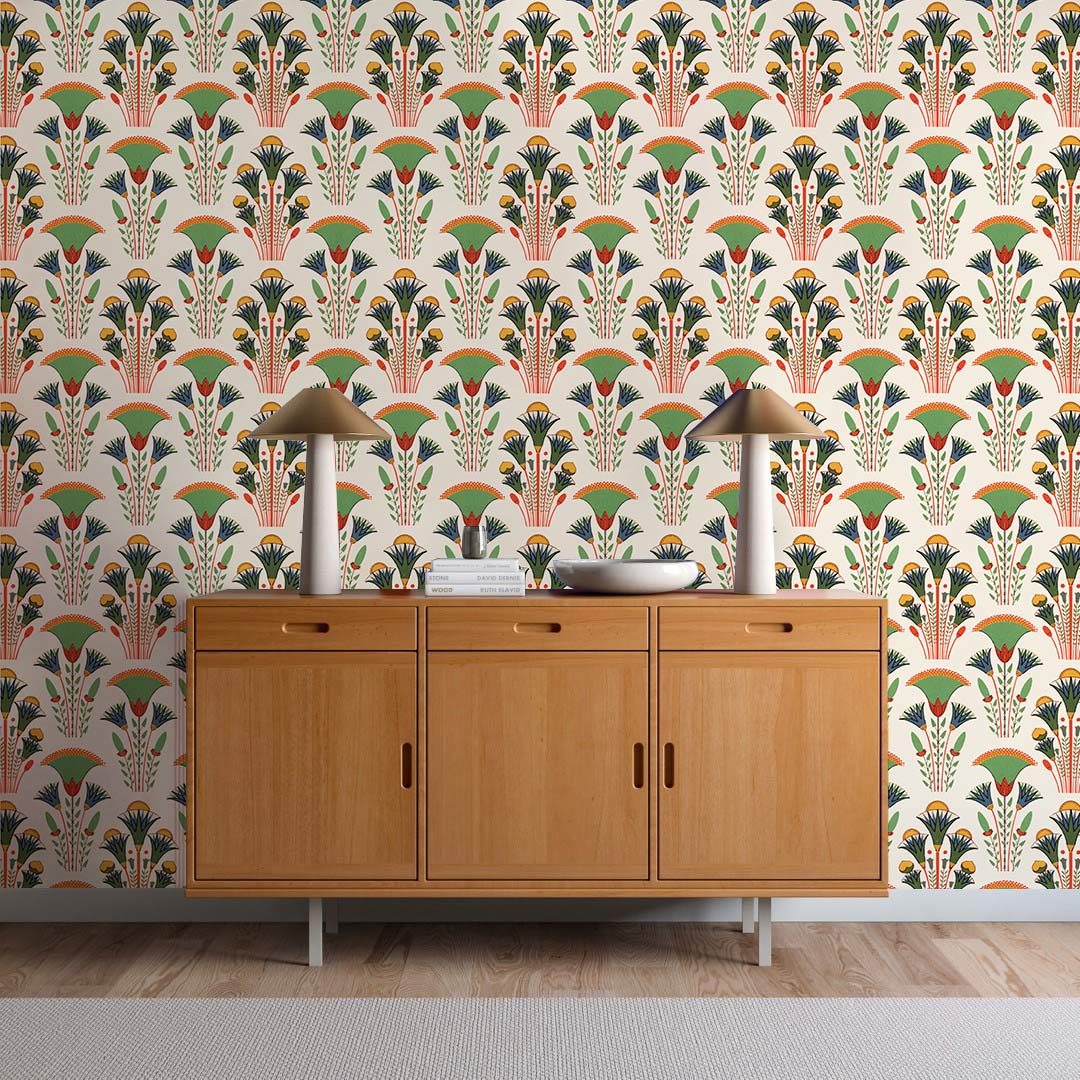 Art Deco floral wallpaper in pastel hues with wooden sideboard, modern lamps, and wood flooring.