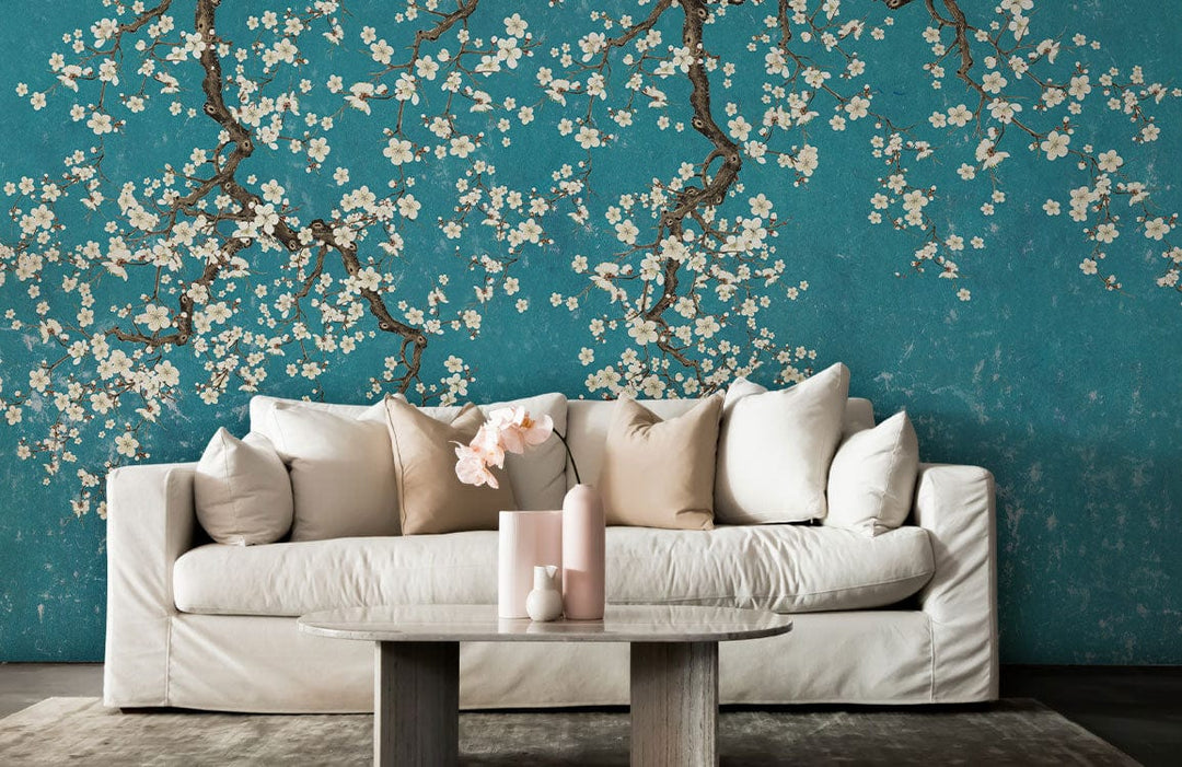 Teal Blossom Branches Wallpaper Mural with white sofa, beige cushions, and wooden table in living room.