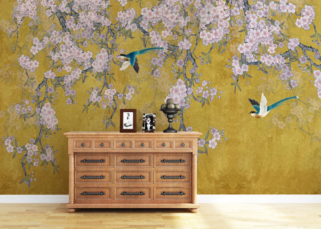Elegant floral wall mural with vintage gold blossoms, birds, and wooden dresser in living room.