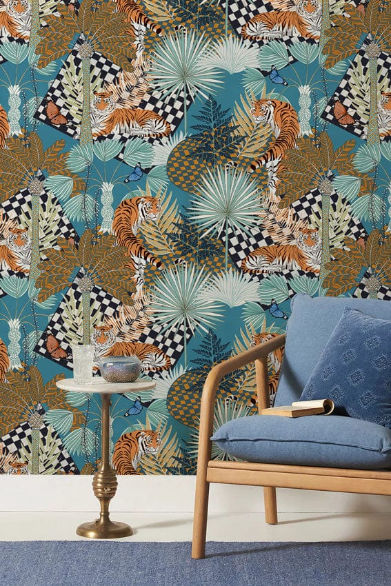 Exotic Jungle Safari Wallpaper features tigers; blue sofa; small table; carpet flooring; vibrant design.