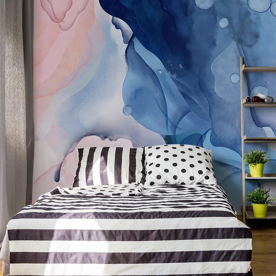 Elegant Watercolour Swirl Mural Wallpaper in pastel hues, bedroom setting, striped bedding, wooden shelves.