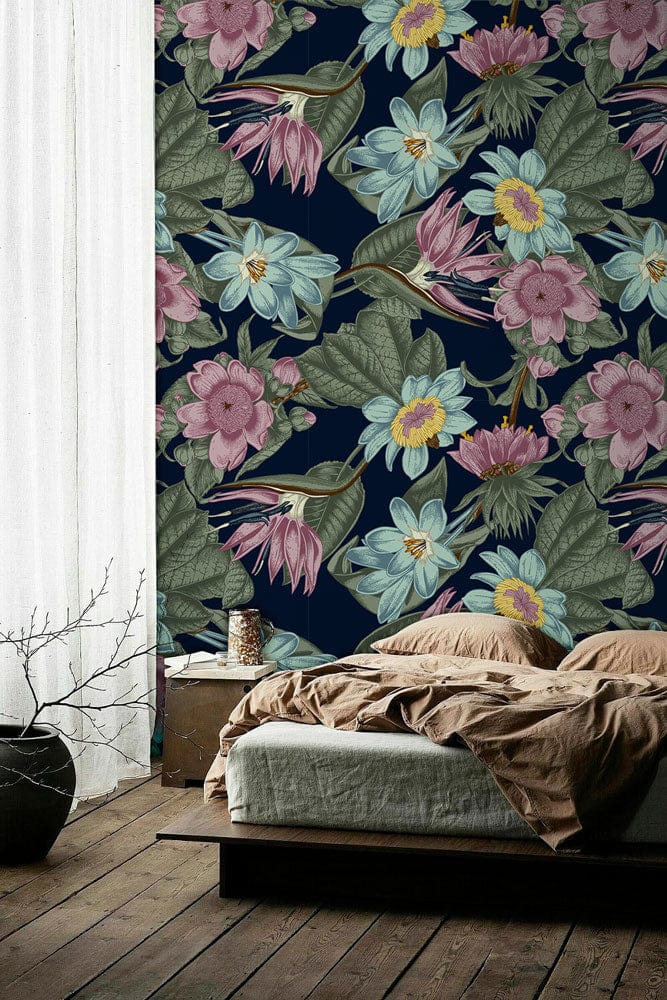 Luxurious navy botanical floral wallpaper in bedroom with wooden floor, beige bedding, and elegant decor.