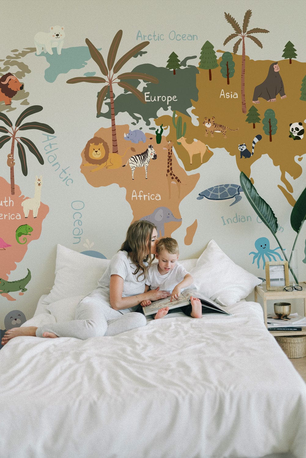 Whimsical World Map Mural Wallpaper in kids' room with bed; educational, colourful adventure for children.