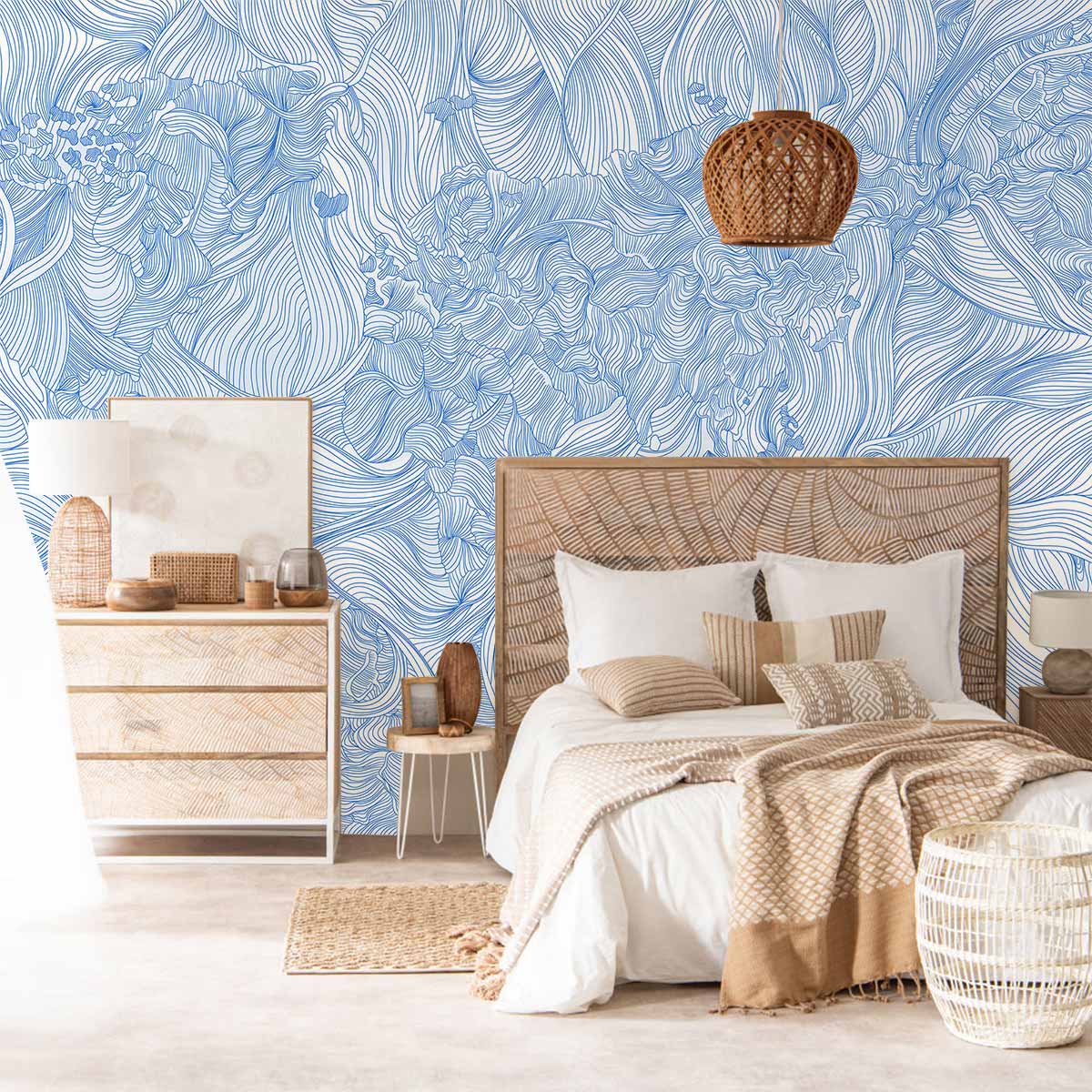 Elegant blue floral line art wallpaper in modern bedroom with beige bed, wicker furniture, and light flooring.