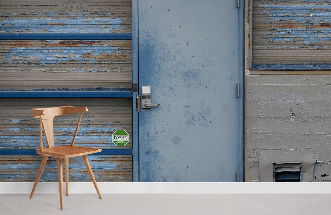Vintage industrial wallpaper featuring blue weathered door with minimalist wooden chair in urban room.