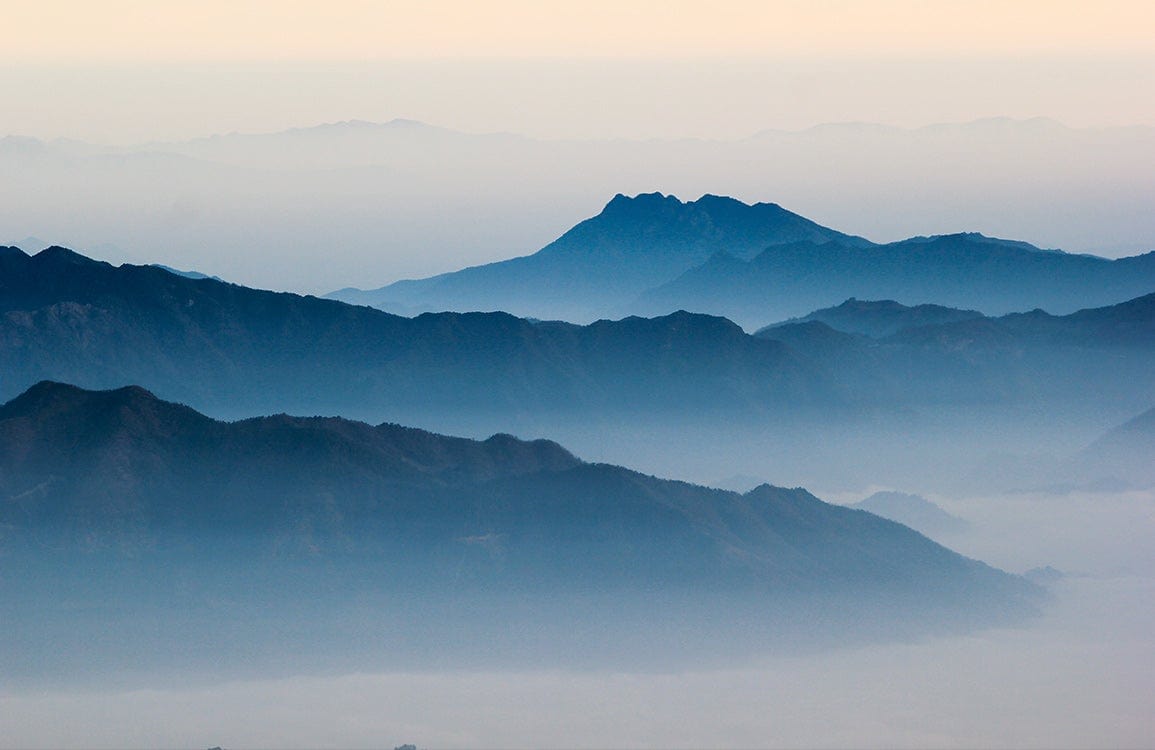 Tranquil Blue Mountain Mist Landscape Mural Wallpaper for Serene Interiors