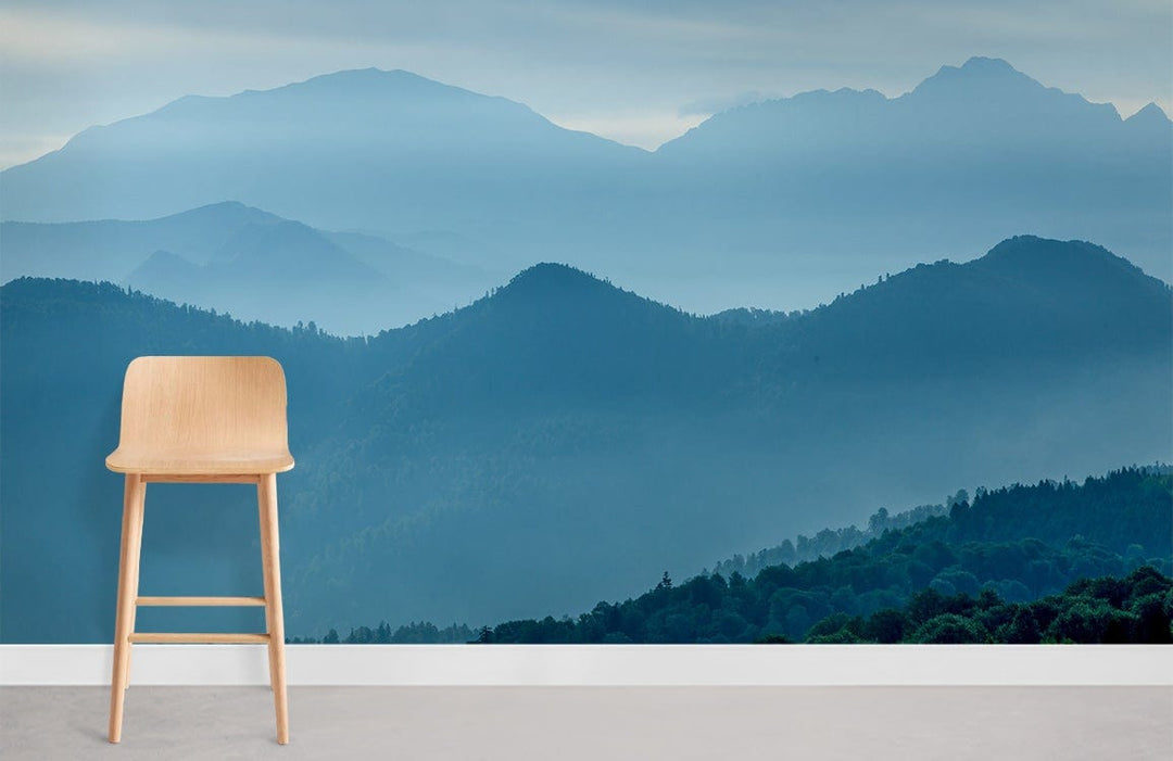 Tranquil Blue Mountain Landscape Mural Wallpaper, serene grey flooring, natural wood chair, calm Décor.