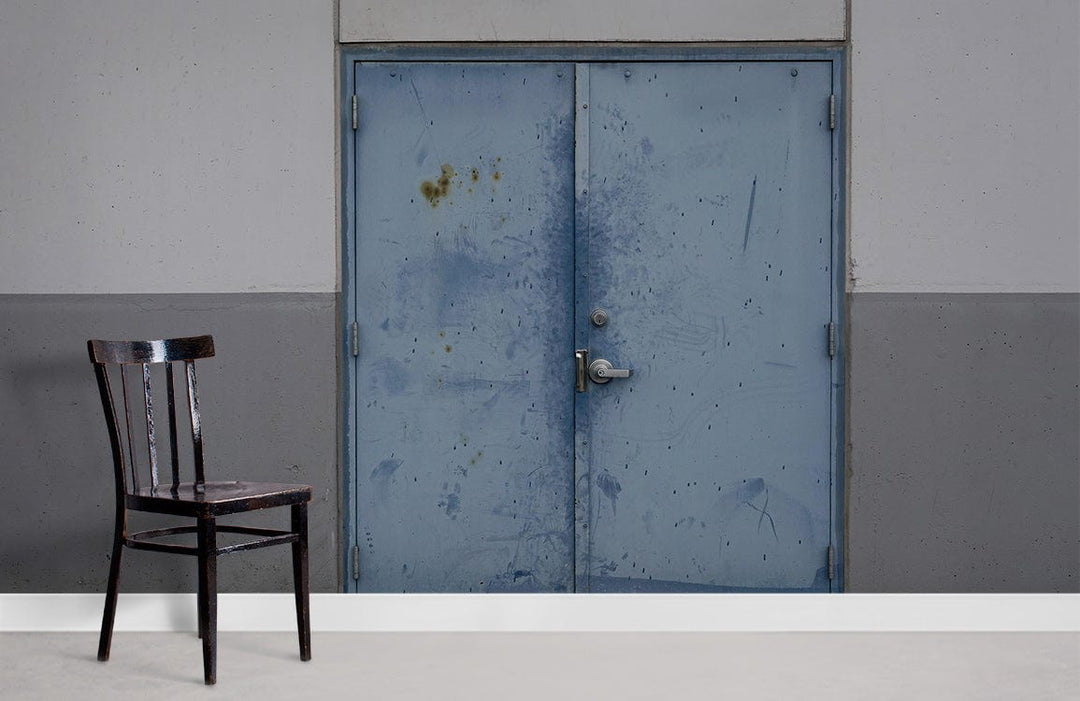 Industrial Chic cement effect door wallpaper mural with chair on concrete flooring, blue-grey tones.
