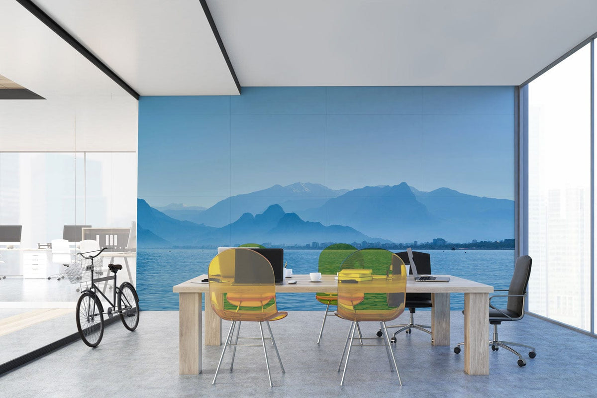 Office interior featuring Tranquil Blue Mountain and Sea Vista Mural Wallpaper, wood table, modern chairs.