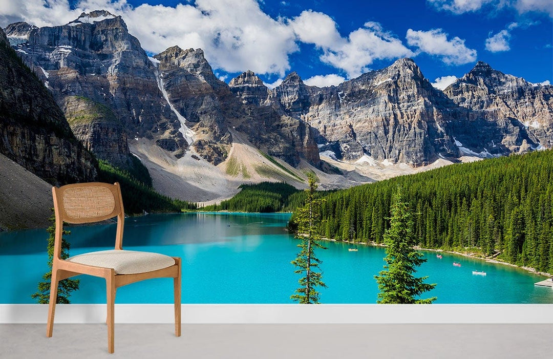 Serene Turquoise Mountain Lake mural wallpaper in minimalist room with wooden chair, grey flooring.