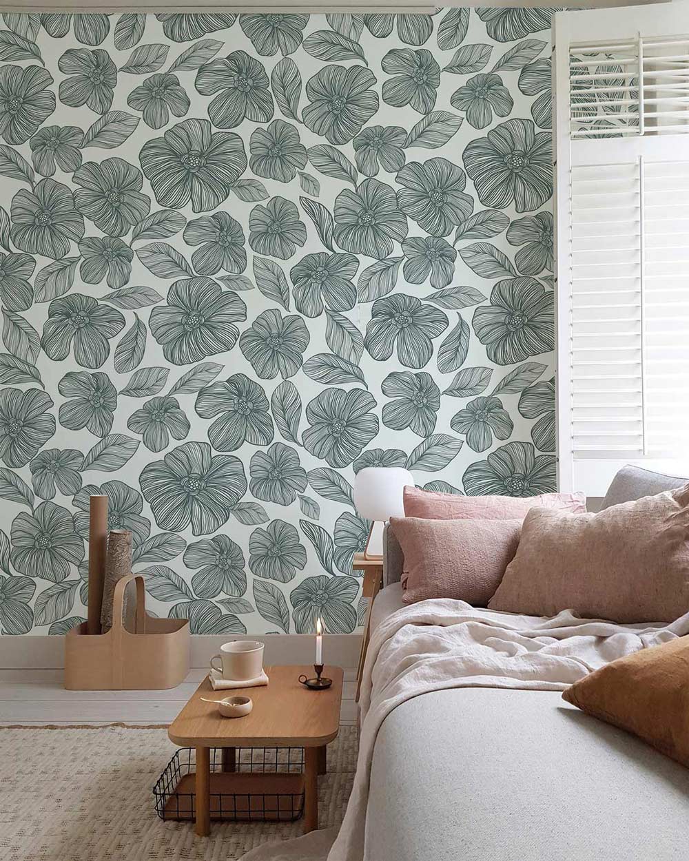 Elegant Sage Green Floral Wallpaper in cosy living room, featuring grey sofa, wooden side table.