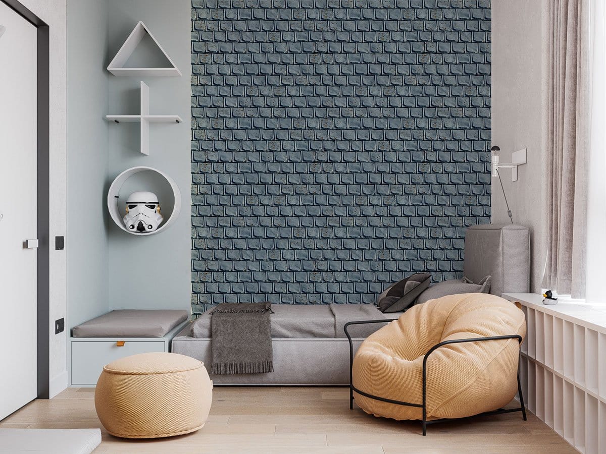 Grey rustic brick wallpaper in modern lounge with beige armchair, grey sofa, light wood flooring.
